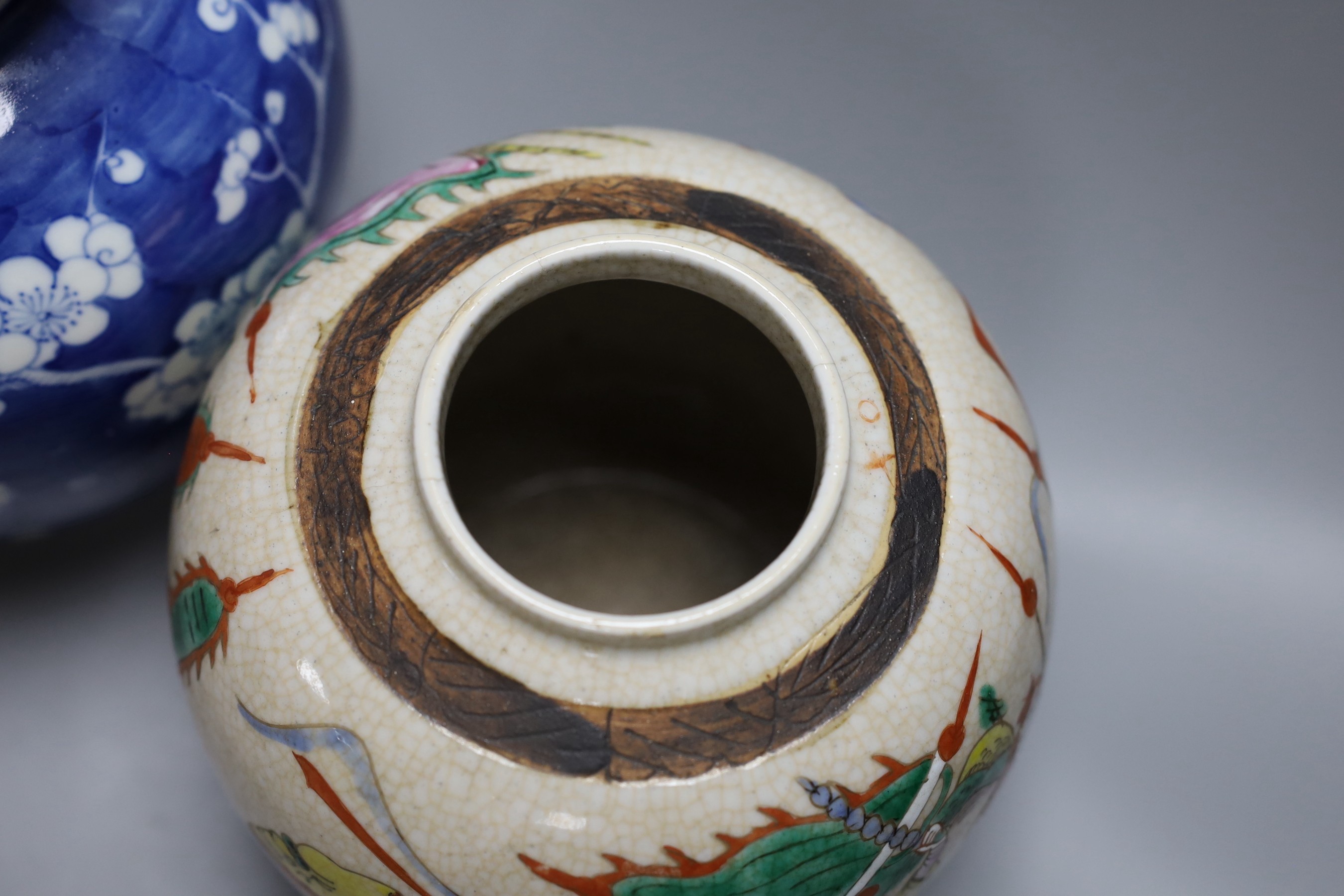 A Chinese crackle glaze vase and jar and a blue with figural decoration, together with a Chinese blue and white prunus double gourd vase, tallest 37cm